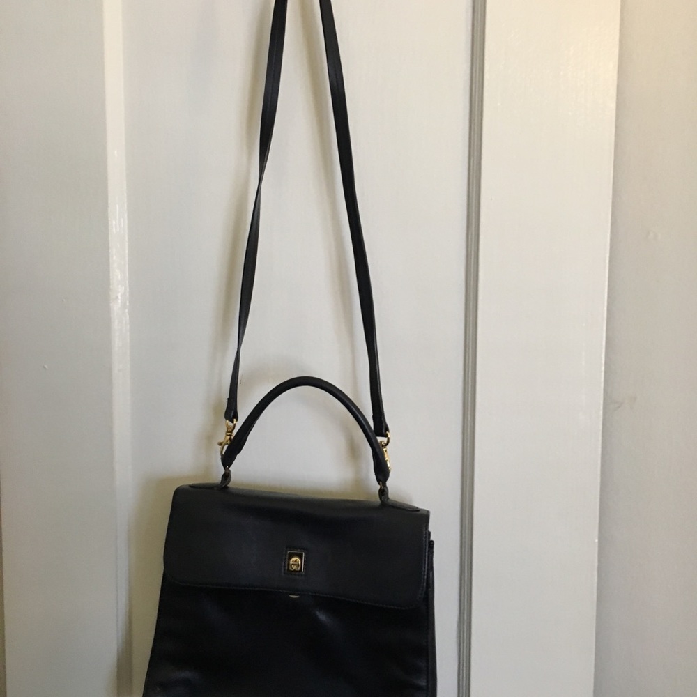 Etienne Aigner navy blue handbag.